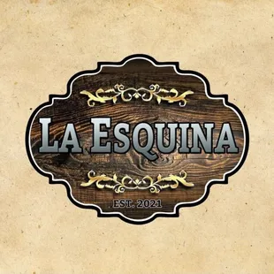 a wooden sign with the word la esquina