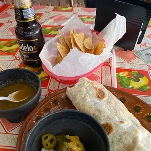 a burrito and a bowl of salsa