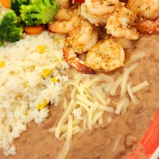 a plate of beans, rice, shrimp, and broccoli
