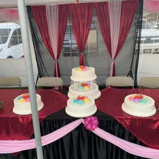 a table with three tiered cakes