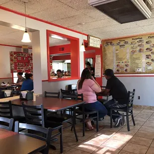 people sitting at tables in a restaurant