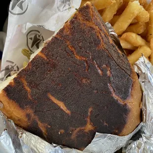 a grilled sandwich and french fries