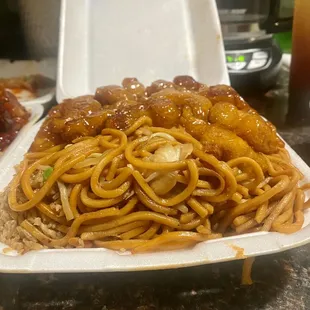 Container was packed with so much food you cant even see the rice! Rice, chow mein, regular orange chicken.
