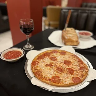 a pepperoni pizza on a table