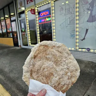 a hand holding a pastry