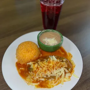 a delicious chile relleno accompanied by delicious rice and beans