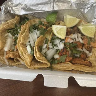 three tacos in a styrofoam container