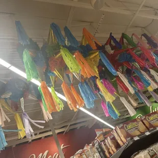 a variety of colorful umbrellas hanging from the ceiling