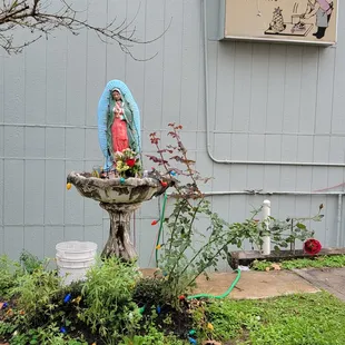 a statue of a woman in a garden