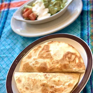 Quesadilla plates served with your choice of guacamole salad and sour cream or rice or beans