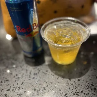 a can of red bull and a glass of beer