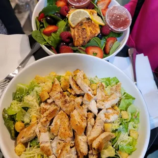 a bowl of salad and a bowl of chicken