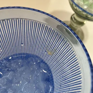 Dirty water glass. Cheese stuck to the inside of the glass.