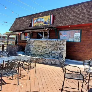 a patio with tables and chairs