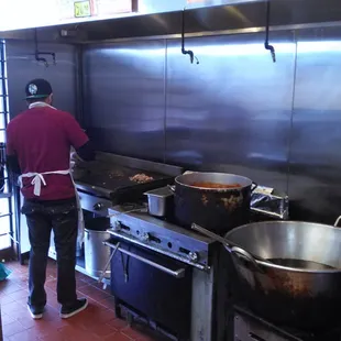 a man preparing food in a commercial kitchen