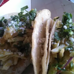 Mahi Mahi tacos topped with a chile piquin - peach vin tossed slaw