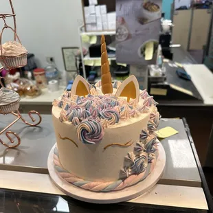 a cake with a unicorn horn on top