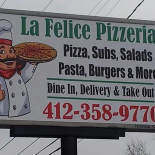 a chef holding a pizza