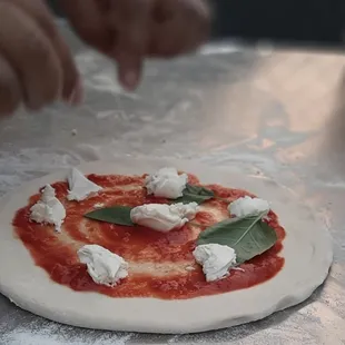 a person making a pizza