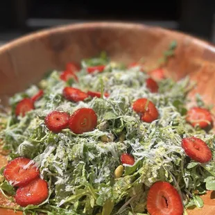 a wooden bowl of salad