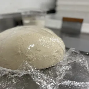 a ball of dough wrapped in plastic