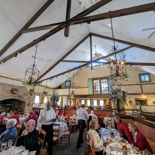a group of people sitting at tables in a restaurant