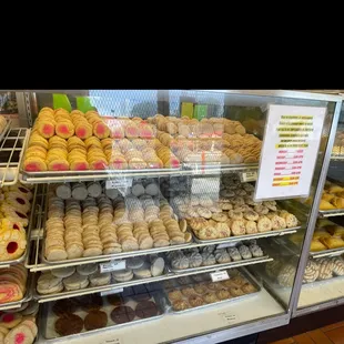 a variety of donuts in a display case