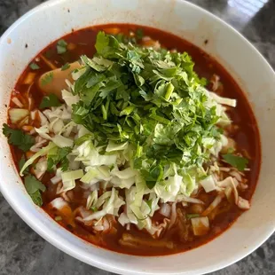 a bowl of soup with shredded cabbage