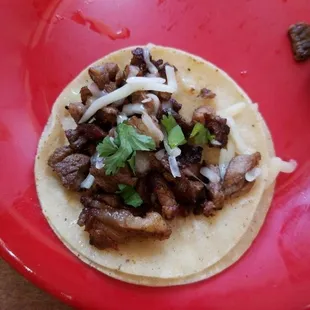 a taco on a red plate