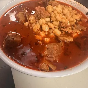 a bowl of soup with meat and beans