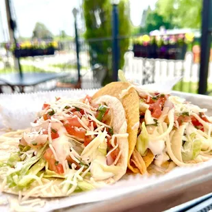 three tacos on a tray