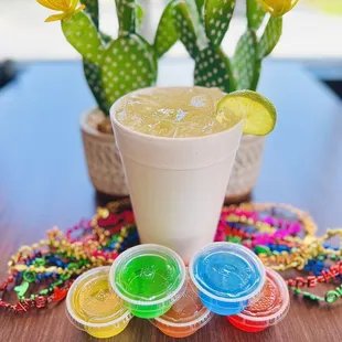 a drink in a plastic cup with a lime slice on the rim