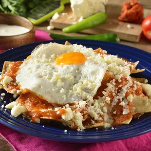 Red or Green Chilaquiles with eggs, sour cream and cheese on top.  Delicious.