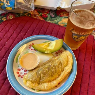a plate of food and a glass of beer