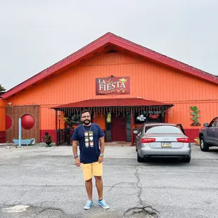 a man standing in front of the restaurant