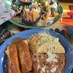 Beef tacos, chicken enchiladas, rice and beans.  Tacos Al Pastor.