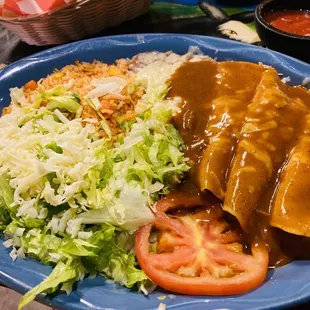 Yolanda 3x chicken enchiladas with rice and beans