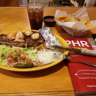 Steak and shrimp with:  Cuba Libré (doble rum) (pictured)  Three shots of Tequila (not pictured)  Three Modelo Especials (not pictured)