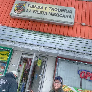 a man standing in front of a mexican restaurant