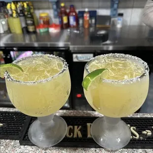 two margaritas on a bar