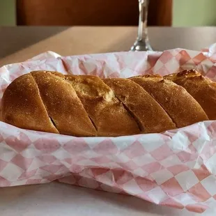 a basket of bread and a glass of wine