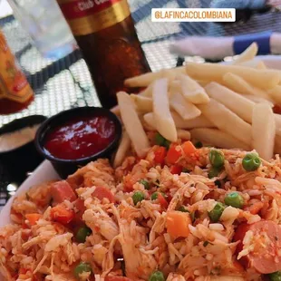 a plate of fried rice and french fries