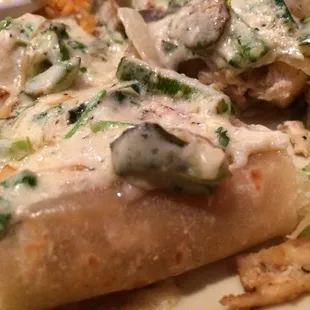 Enchiladas Poblanas.  Tasty chicken with a veggie cream sauce.  Excellent!