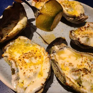 Grilled oysters are huge right now. Lime slice held up for scale.