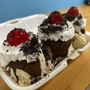 two ice cream sundaes in a styrofoam container