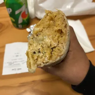 a person holding a burrito
