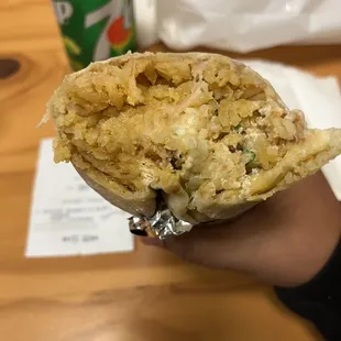 a person holding a burrito