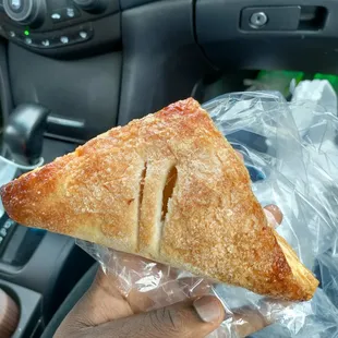 a hand holding a pastry