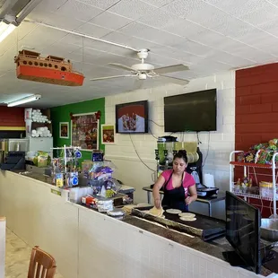 a woman behind a counter in a restaurant