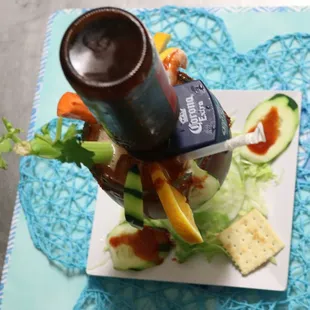 a plate of food and a bottle of beer